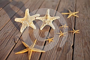 Starfish on a wooden pier poured over a wooden deck. Summer vacation concept. Holidays by the sea