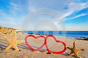 Starfishes with hearts on the sandy beach