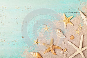 Starfishes and seashells on sand for summer holidays and travel background