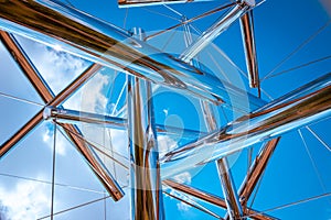 Staring at the clouds through a chrome statue