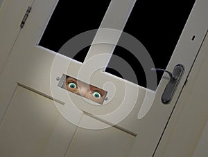 staring eyes peering through door letterbox photo