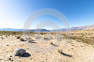 Stark dry southern California desert with blue sky, lonely empty and desolate, adventure hiking camping solitude, peaceful