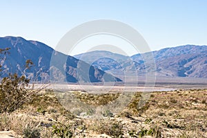 Stark dry southern California desert with blue sky, lonely empty and desolate, adventure hiking camping solitude, peaceful