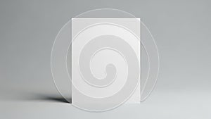 A stark white rectangular object casting a soft shadow on a gray background