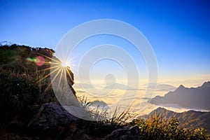 Starlight Sunrise scene with the peak of mountain called Phu Chifa with Fog over the city below photo