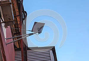 Starlink satellite dish, an internet constellation operated by SpaceX, is installed on the wall of an apartment building