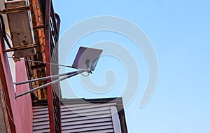 Starlink satellite dish, an internet constellation operated by SpaceX, is installed on the wall of an apartment building