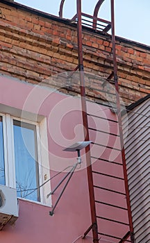 Starlink satellite dish, an internet constellation operated by SpaceX, is installed on the wall of an apartment building