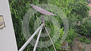 Starlink satellite dish, an internet constellation operated by SpaceX, is installed on the wall of an apartment building.