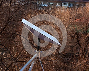 Starlink satellite dish, an internet constellation operated by SpaceX, is installed on the wall of an apartment building. View