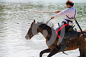 STAROCHERKASSK, RUSSIA - CIRCA SEPTEMBER 2020: a young Don Cossack on horseback