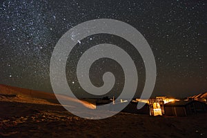 Starry night above the desert campsite in Sahara
