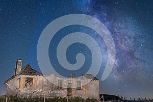 Starry night and Milky Way with abandonned farm house in France