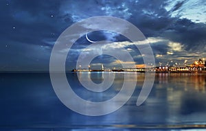 Starry night and moon at sunset sea harbor cruise line night light reflection on sea water seascape panorama Tallinn Estonia