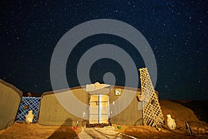 Starry night sky above the tent in a desert campsite