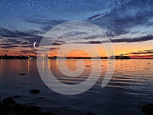 Seascape Sunset Night moon in Harbor ship  horizon blue lilac water light reflection twilling seawater pink Baltic sea  background photo