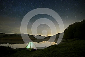 Starry night on wild camp by the lake