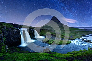 Starry sky on Kirkjufellsfoss waterfall.