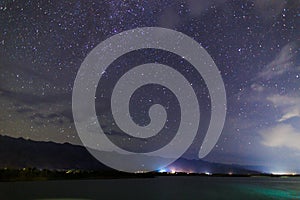 Starry sky on the lake. Night landscape. Sky with clouds. Kyrgyzstan, Lake Issyk-Kul