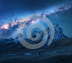 Starry sky with Milky Way above mountains at night in summer.