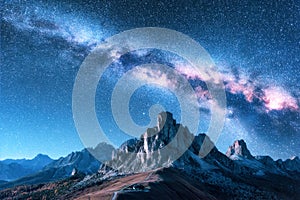 Starry sky with Milky Way above mountains at night in summer.