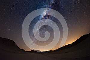 Starry sky and Milky Way arc, with details of its colorful core, outstandingly bright, captured from the Namib desert in Namibia,