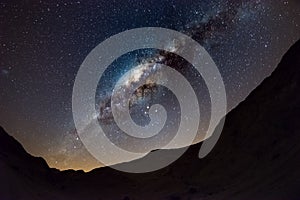 Starry sky and Milky Way arch, with details of its colorful core, outstandingly bright, captured from the Namib desert in Namibia