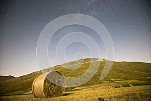 Starry sky and Milky Way in the plain of Castelluccio di Norcia. Apennines, Umbria, Italy