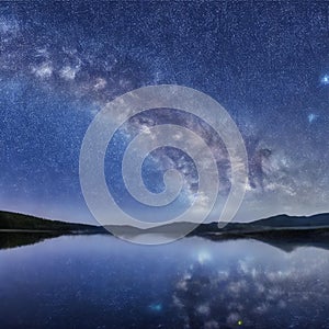 Starry sky reflected in lake. Constellations. Night with starry sky. Shining stars