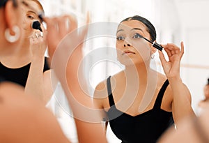 With stars blazing, see me shine. a group of ballet dancers preparing to go on stage and applying makeup together in a