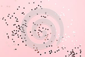 Stars confetti scattered on pink pastel background