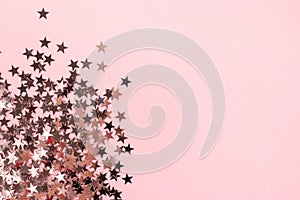 Stars glitter scattered on pink pastel background