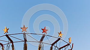 Stars of a light bulb from a carousel. Amusement Park.