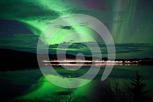 Stars and Northern Lights over dark Road at Lake