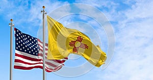New Mexico state and the american flag waving on a clear day photo