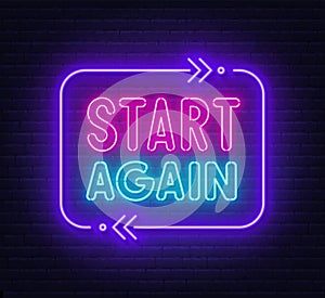 Start again neon sign on a brick background.
