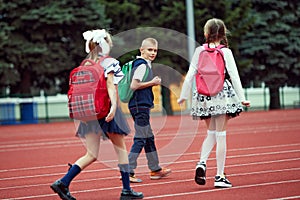 Start. Back to school, kids and education concept. Girls and boy dressed in school uniform as elementary student