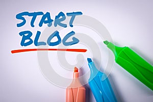 START BLOG concept. Text and colored markers on a white background