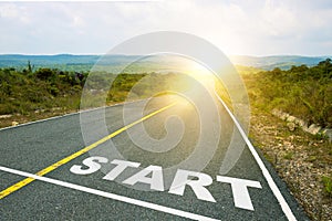 Start, concept photo of asphalt road. Motivational inscription on the road going forward. The beginning of a new path. A