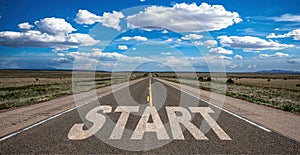 Start concept. Text sign on a long straight road, blue sky background