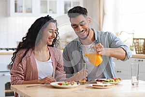 Start Of The Day. Happy Arab Couple Eating Tasty Breakfast In Kitchen