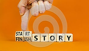 Start or finish story symbol. Concept words Start story and Finish story on wooden cubes. Beautiful orange table orange background