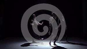 Start graceful contemporary dance of three dancers on black, shadow, slow motion