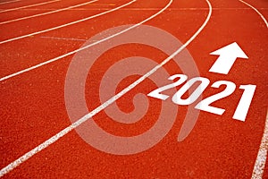 Start line to 2021 on running court represents the beginning of a journey to the destination in business planning, strategy and