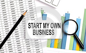 START MY OWN BUSINESS text on white card on the chart background