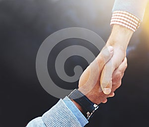 The start of a new partnership. Closeup shot of two businesspeople shaking hands.