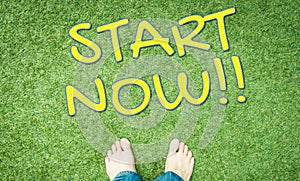 Start now concept text with human foot on grass