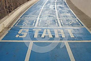 Start point, blue sport running track with sign walk, jogging or run