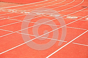 Start of red athletic track with numbers