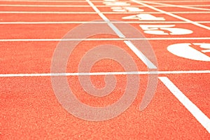 Start of red athletic track with numbers